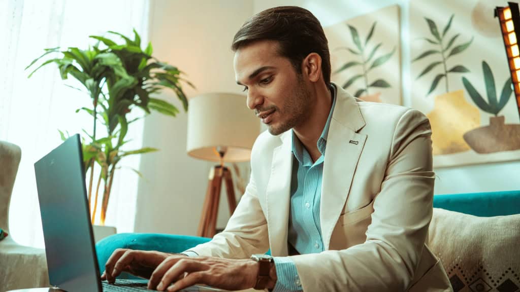 A professional man is working on a laptop