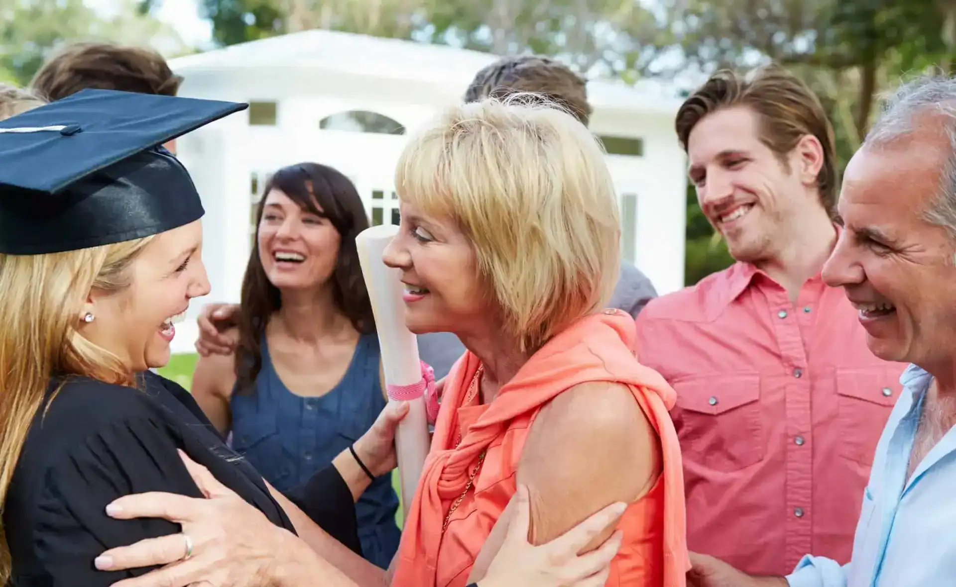 graduate with parents smiling