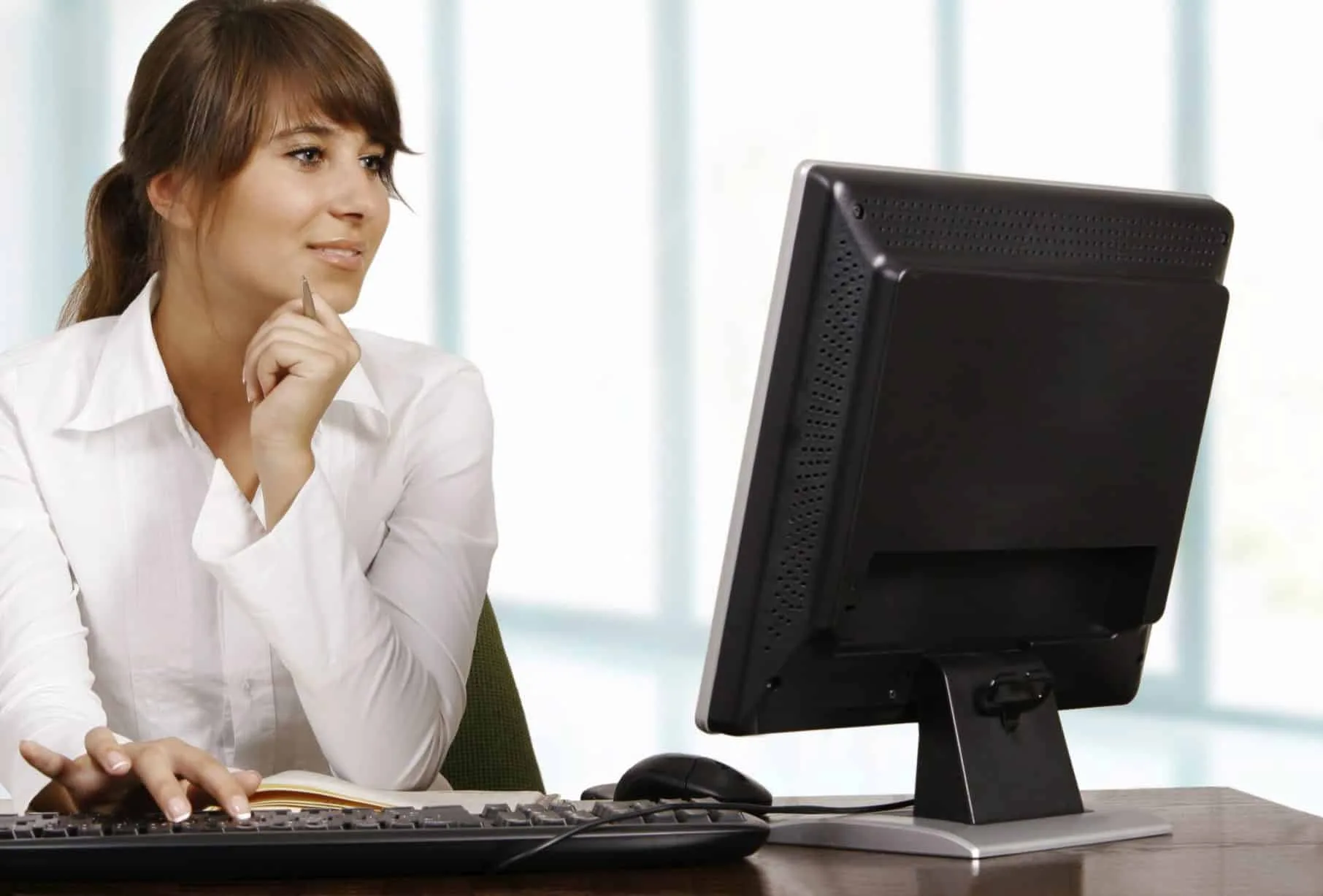 professional woman looking at computer 