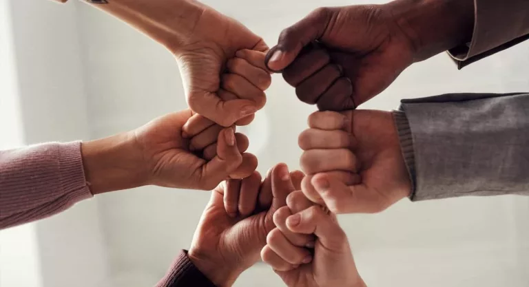 Diverse-hands-in-a-team-huddle-with-fists-together2-scaled-e1591638994741
