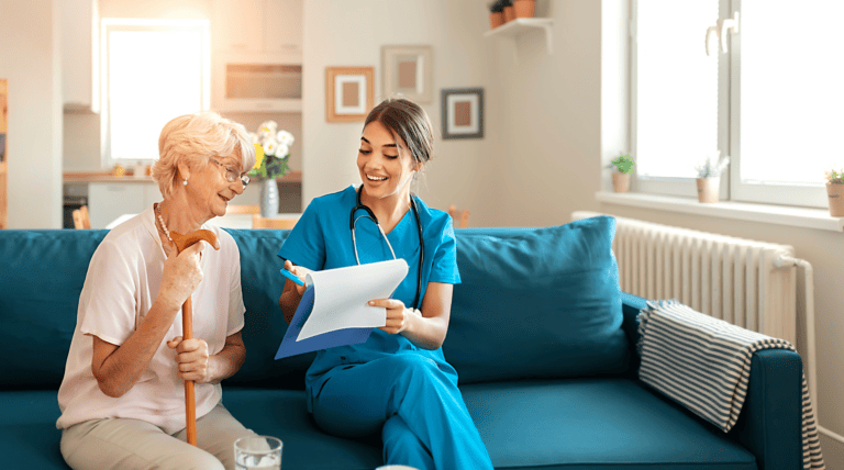 Healthcare worker consulting with elderly patient at home