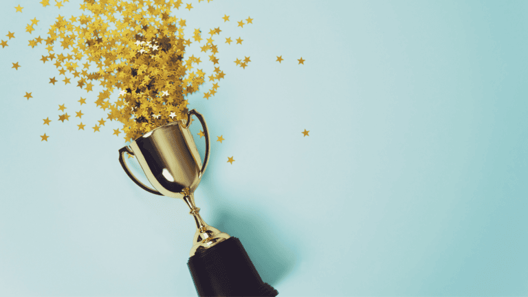 Am image of a trophy with gold glitter spilling out of it