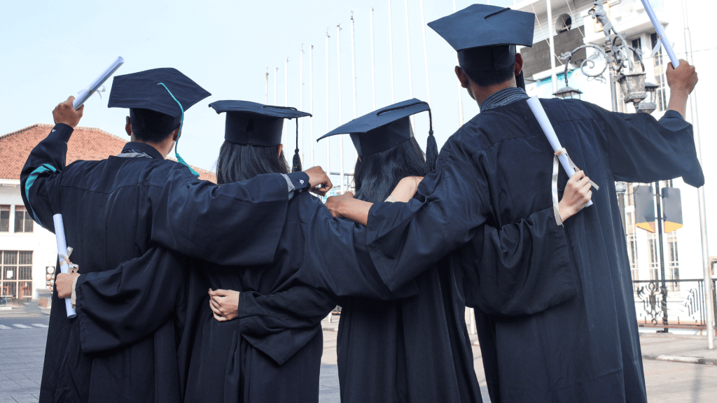 a group of people in graduation gowns are standing on the street