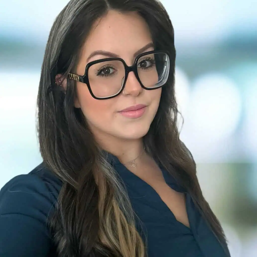A smiling woman wearing glasses