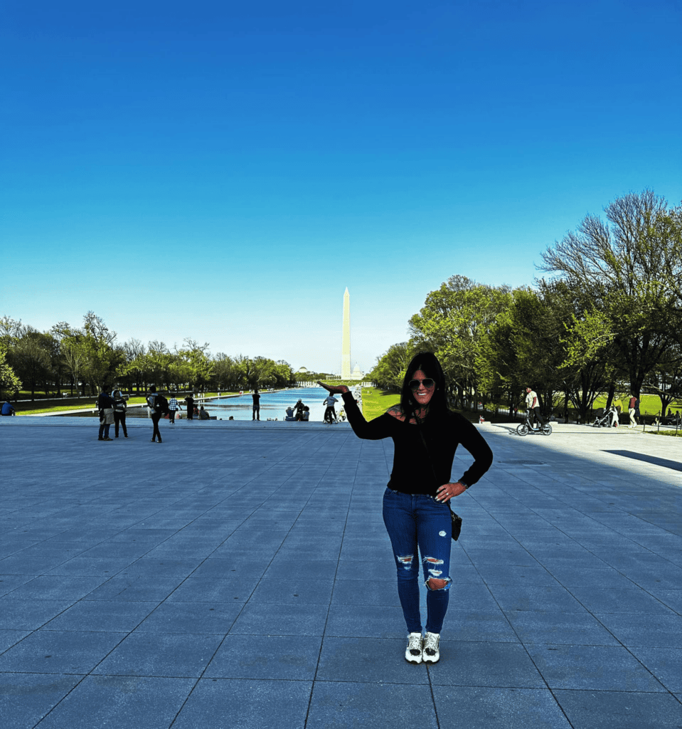 Individual posing with the Washington Monument in the background