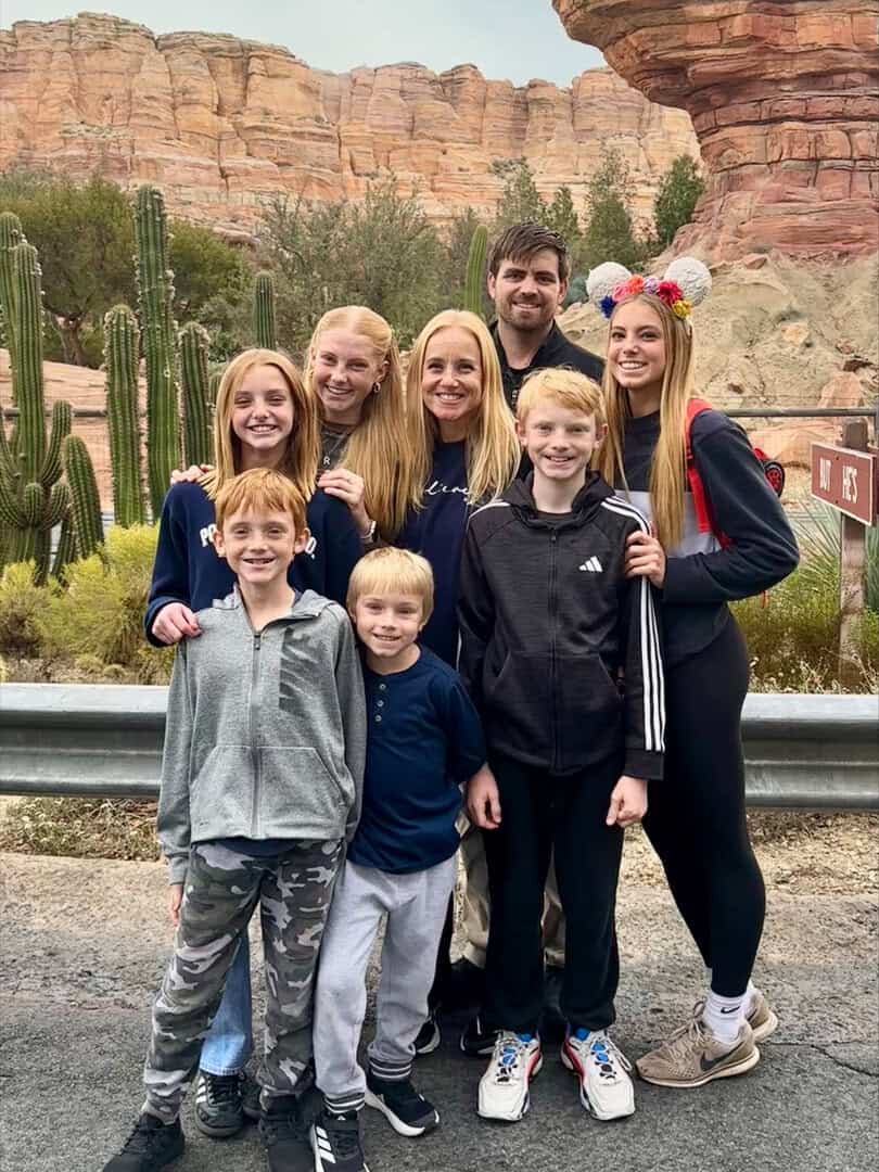 A smiling family in front of an Arizona landscape