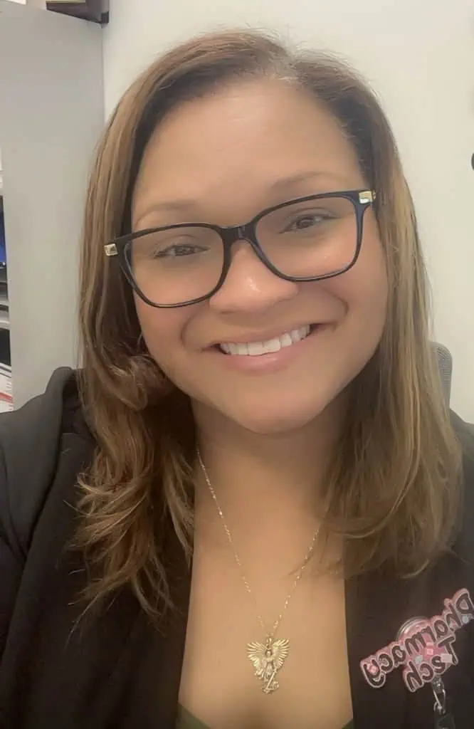 A smiling woman wearing glasses
