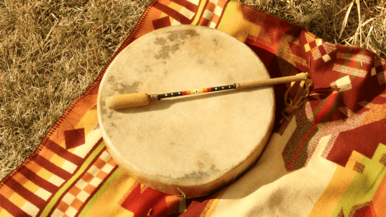 a drum sits on top of a blanket in the grass