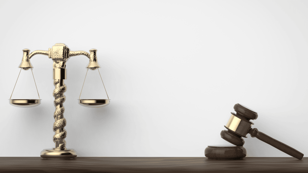 judge gavel and scales of justice on wooden table