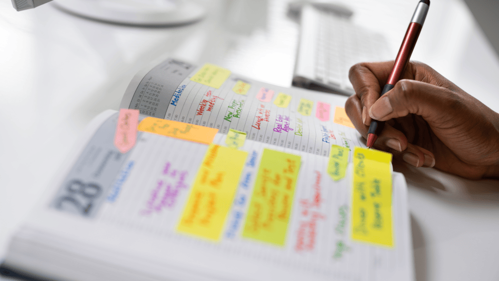 A person writing in a calendar