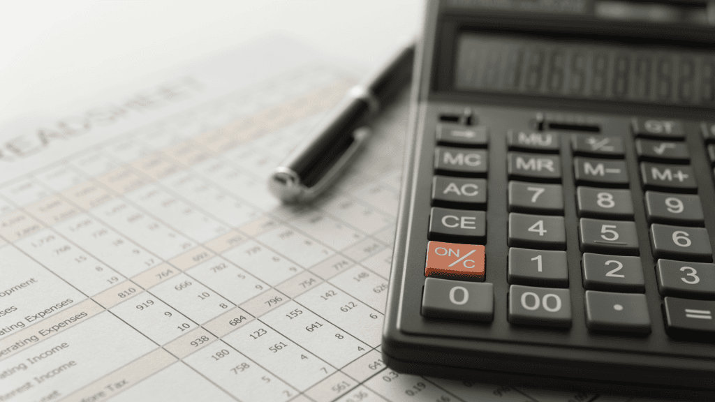 a calculator and pen on a financial statement