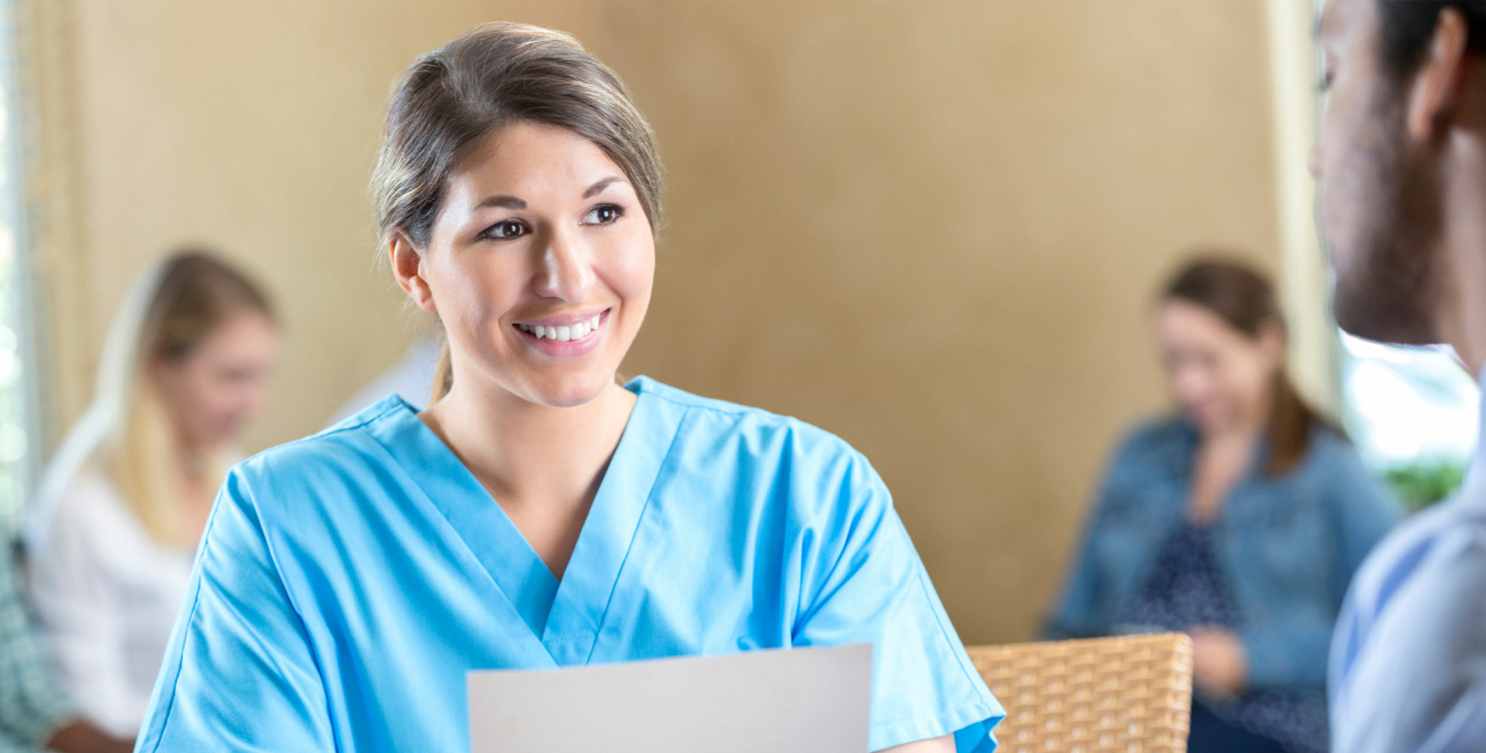 Medical Professional Women Smiling behind Front Desk