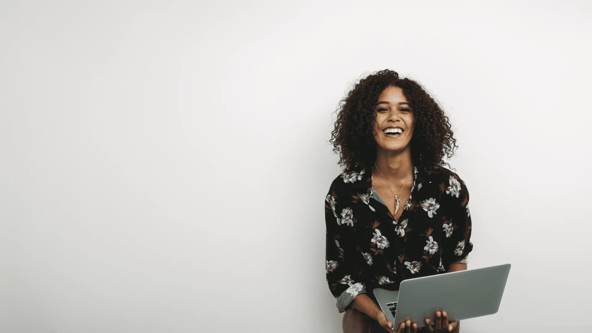 black woman with laptop smiling