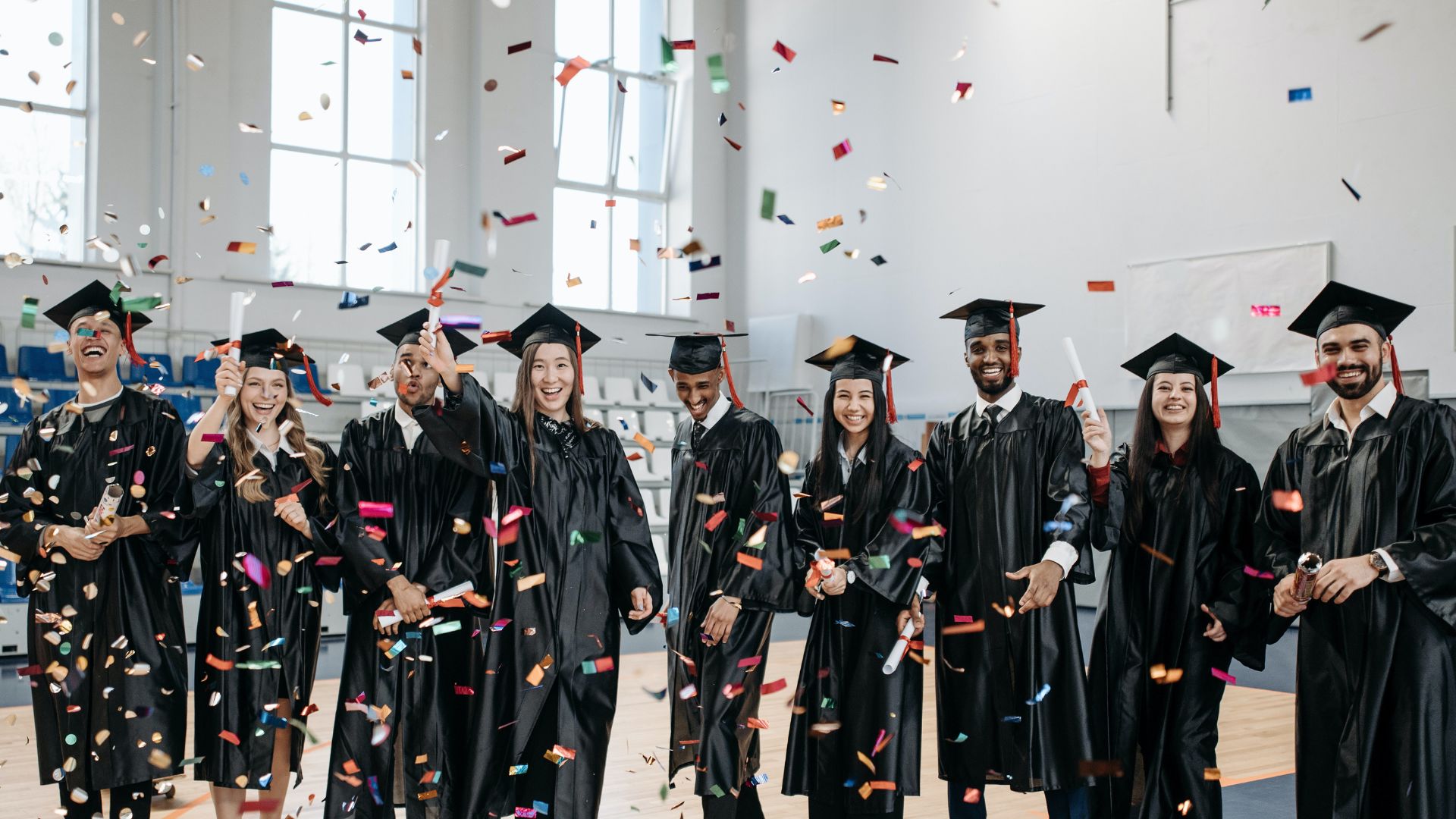 college graduates with confetti