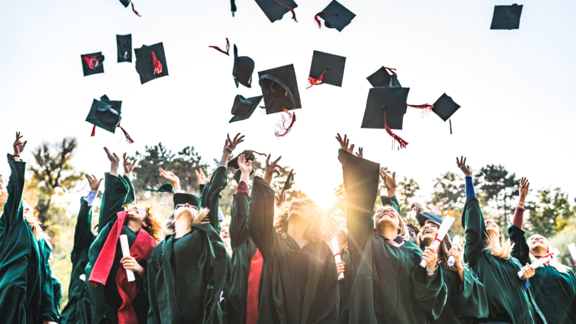 grads throwing up graduation caps