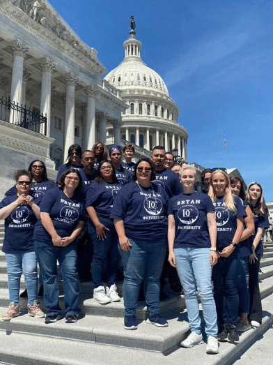 Group of individuals in matching shirts in front of Capitol Building